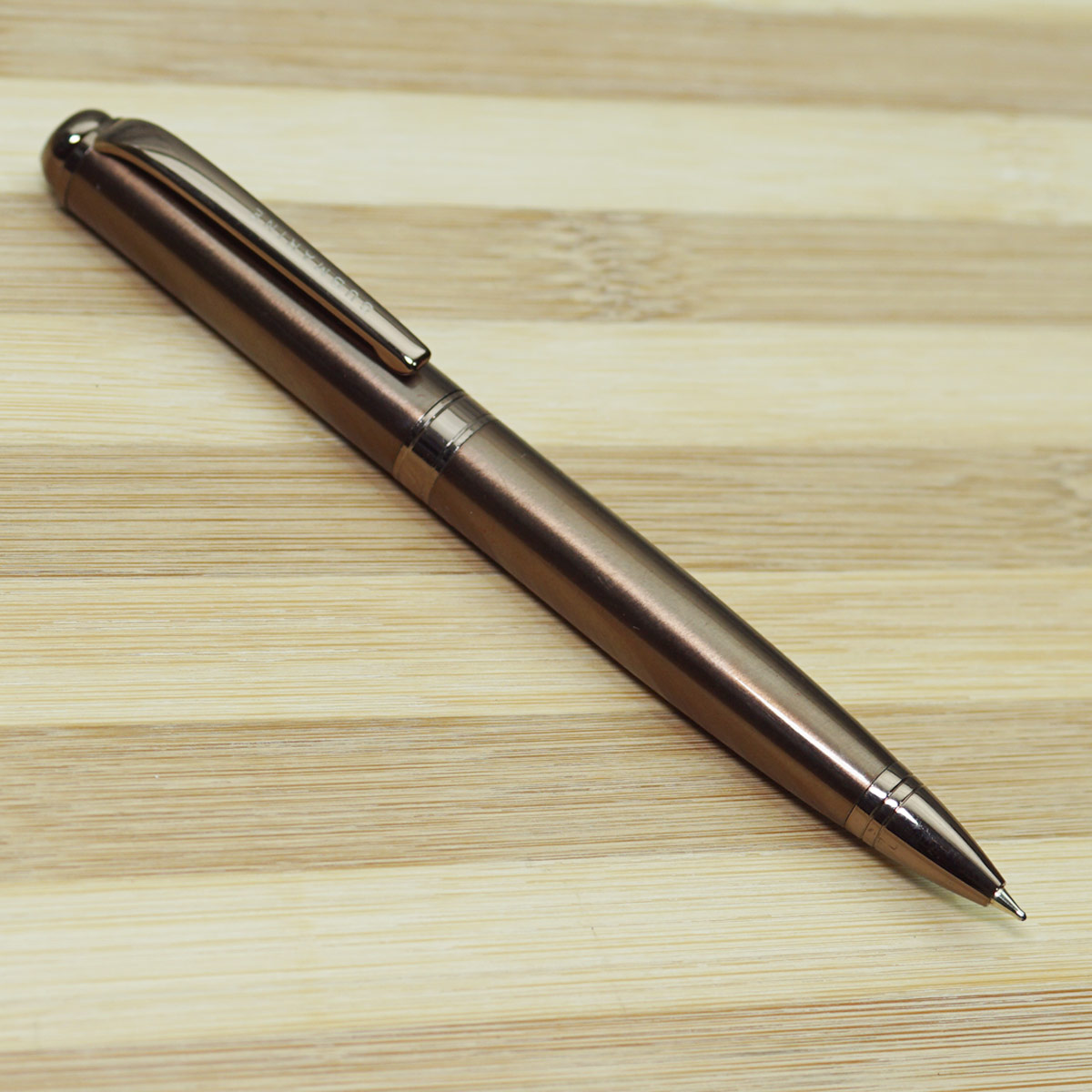 Submarine 1001 Coffee  Copper Color Body With Coffee Fragrance Writing  And Stone On Top Fine Tip Twist Type Ball Pen SKU 22664