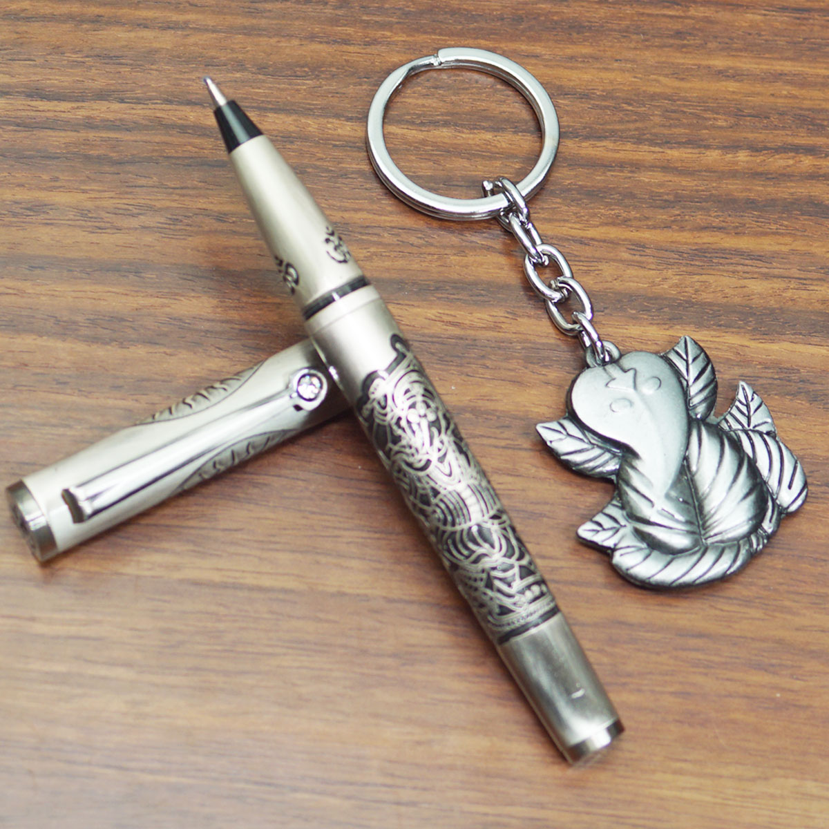 penhouse.in Metallic Silver Color Body With Engraved Lord Ganesh Designed Body Medium Tip Roller Ball Pen And With Lord Ganesh Designed Keychain Set SKU 23385