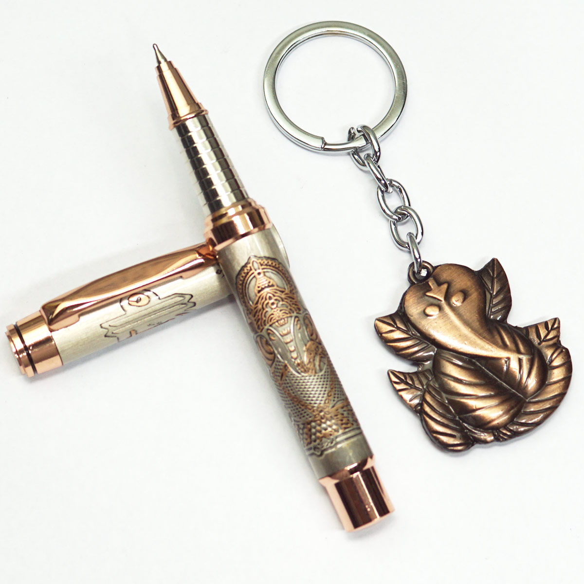 penhouse.in Silver Grey Color Body With Copper Engraved Lord Ganesh Designed Body Medium Tip Roller Ball Pen And With Lord Ganesh Designed Keychain Set SKU 23387