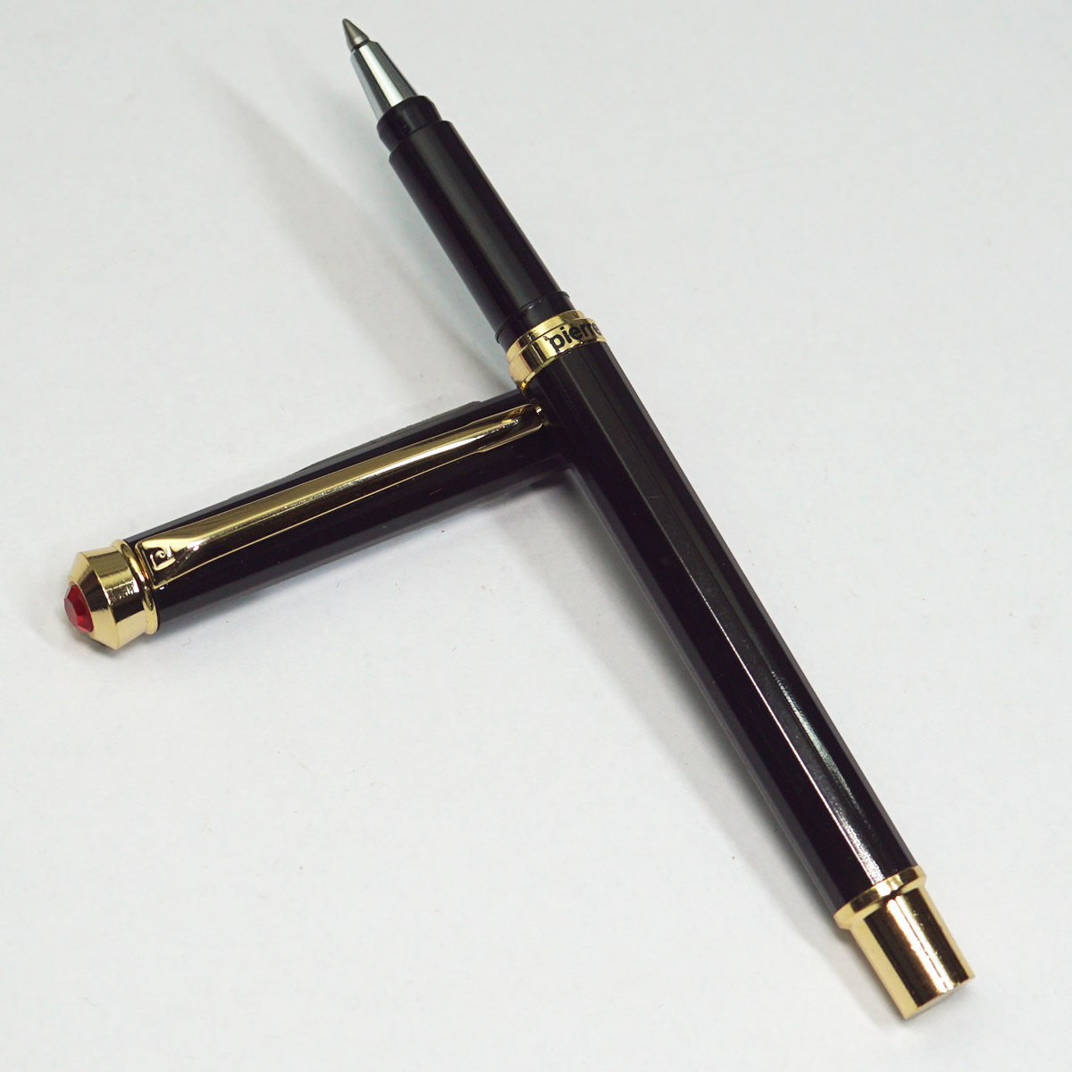 Pierre Cardin Jewel Black Color Body With Golden Color Clip And Top On Red Stone On Cap Medium Tip Roller Ball Pen SKU 23527