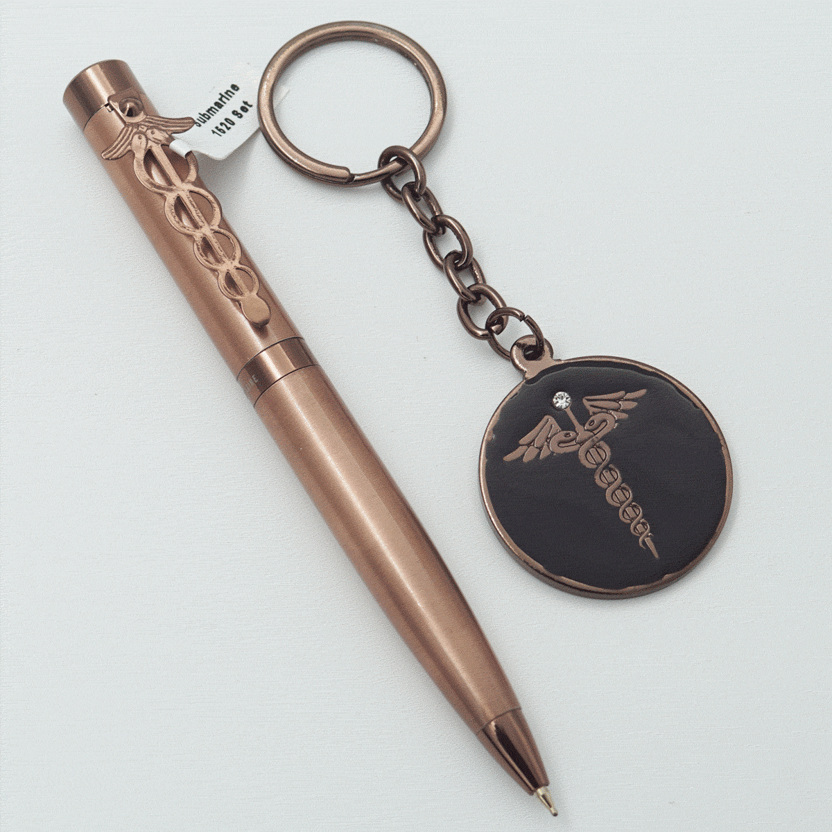 Submarine 1520 Copper Color Body With Cap Fine Tip Twist Type Ball Pen And Doctor Symbol Keychain Set SKU 23708