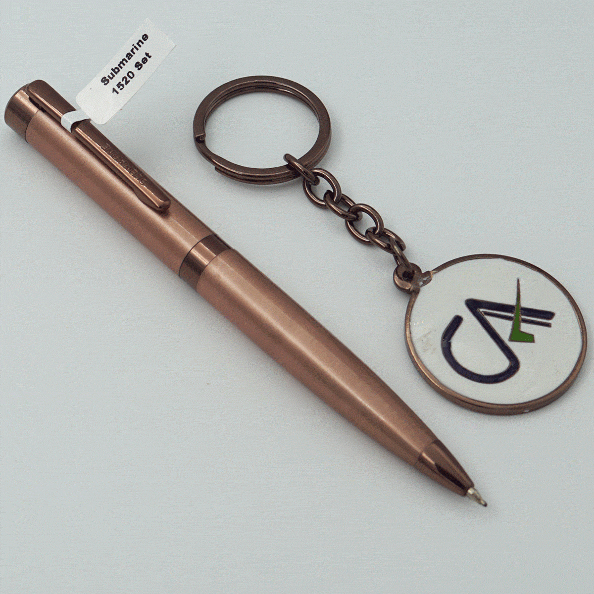 Submarine 1520 Copper Color Body With Cap Fine Tip Twist Type Ball Pen And CA Symbol Keychain Set SKU 23894