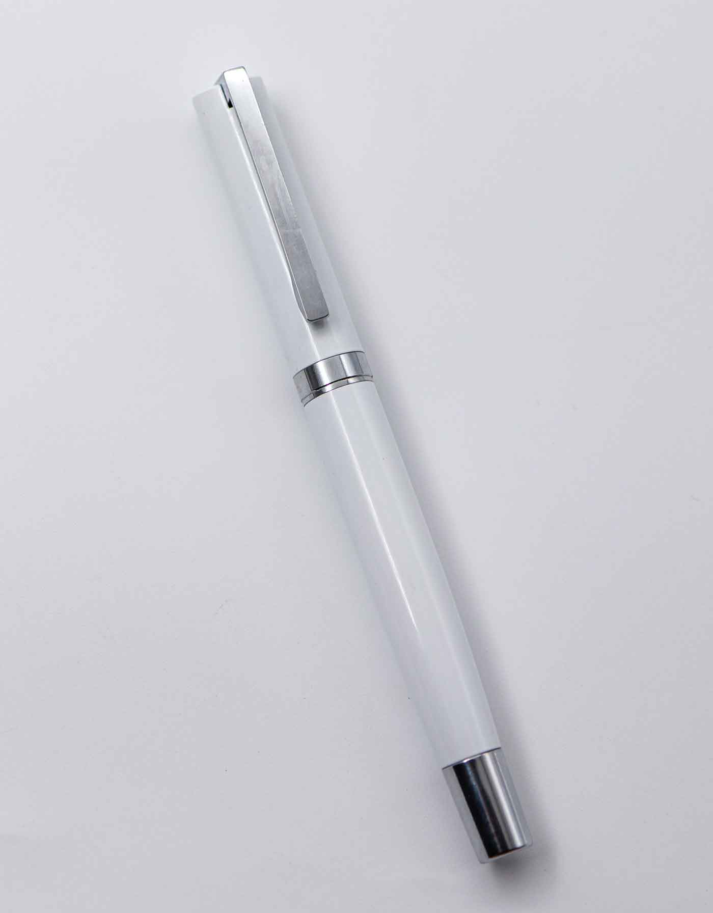 Penhouse.in White Color Body With Silver Clip And Trim Medium Tip Cap Type Roller Ball Pen SKU 25172