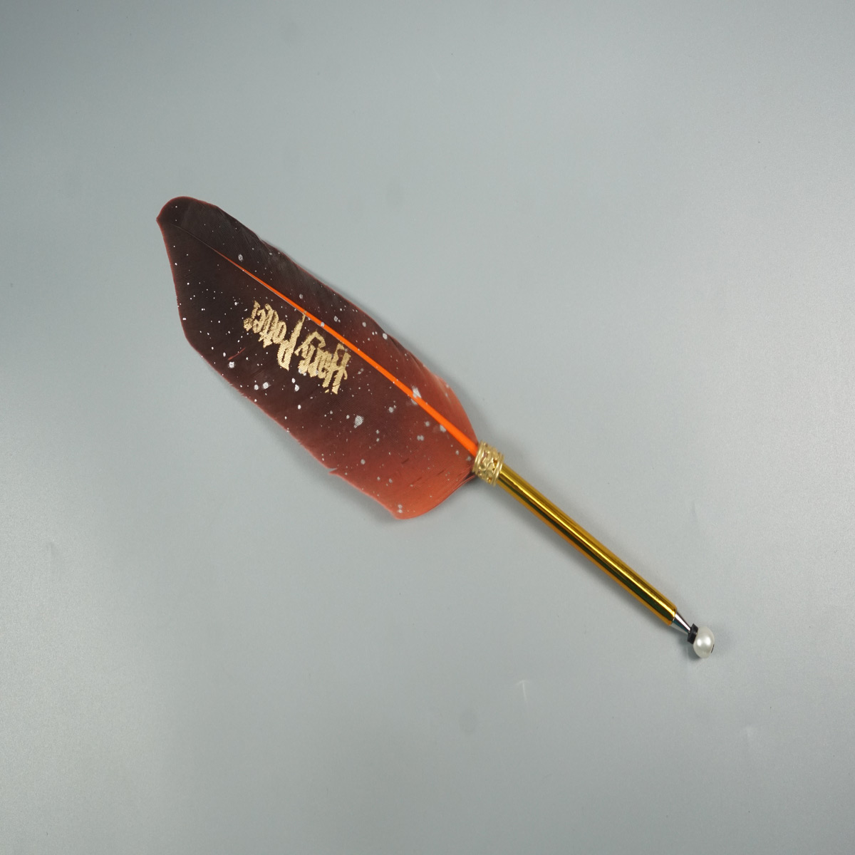 penhouse.in Harry Potter Feather Orange Color with Gold Body Quill Ball Pen SKU 28548