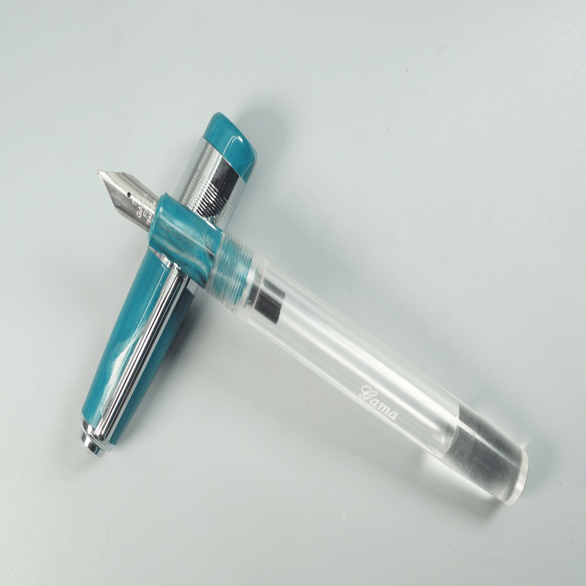 Gama Acrylic Transparent Body with Turquoise Blue Color Cap and Grip Fine Nib Silver Clip and Trim Eyedropper Fountain Pen SKU 28914