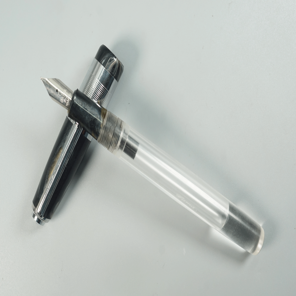 Gama Acrylic Transparent Body with Black Color Cap and Grip Fine Nib Silver Clip and Trim Eyedropper Fountain Pen SKU 28915