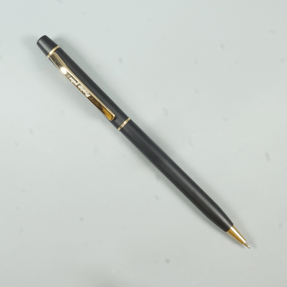 Realto Pulse Black Color Body With Gold Color Clip Slim Twist Type Ball Pen  SKU 28963
