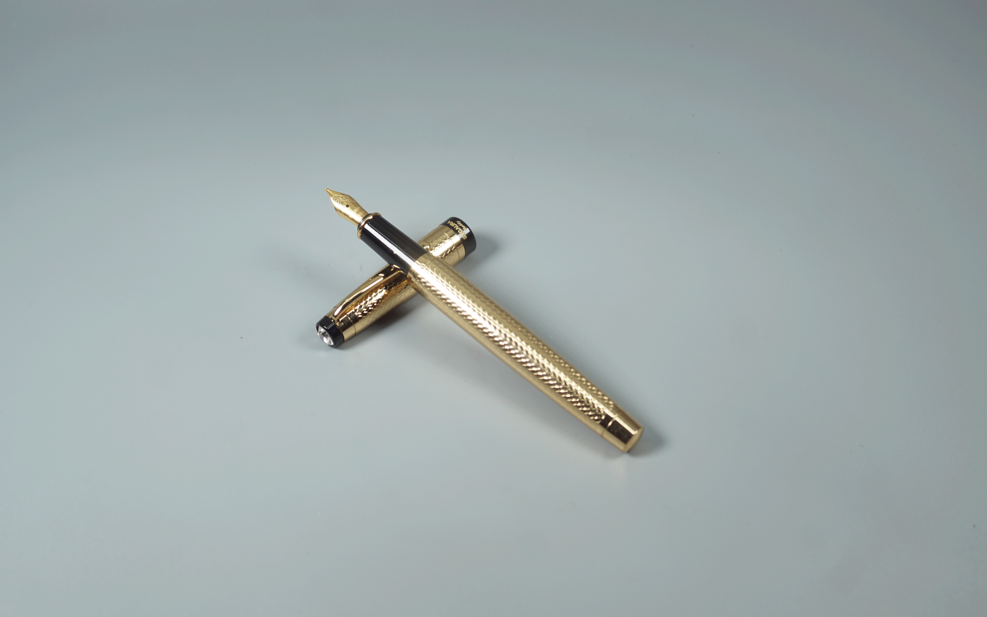 Sigaura Rubby Full Gold Body With Gold Clip And Black Trim Fine Tip And Cap Top On White Stone Cap Type Fountain Pen SKU 29099