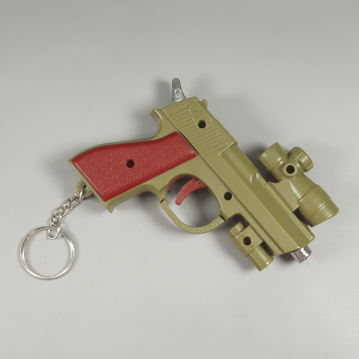 Penhouse.in Stationeries  Green Color Fake Gun Laser Trick Playing Toy Keychain SKU 52325
